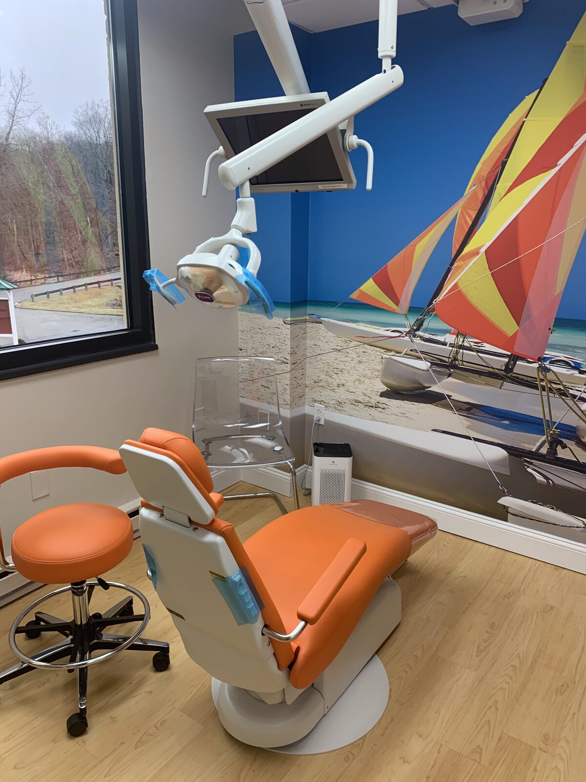 Dental treatment light over an orange Royal chair